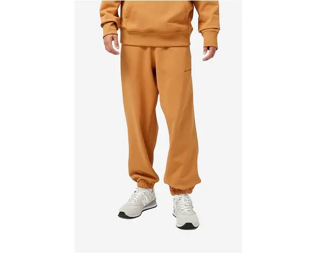 New Balance pantaloni de trening din bumbac culoarea portocaliu, uni
